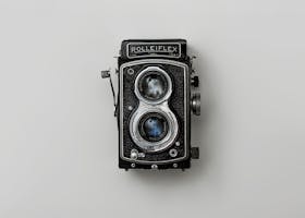 Classic Rolleiflex camera showcased against a simple background, emphasizing nostalgia and vintage design.